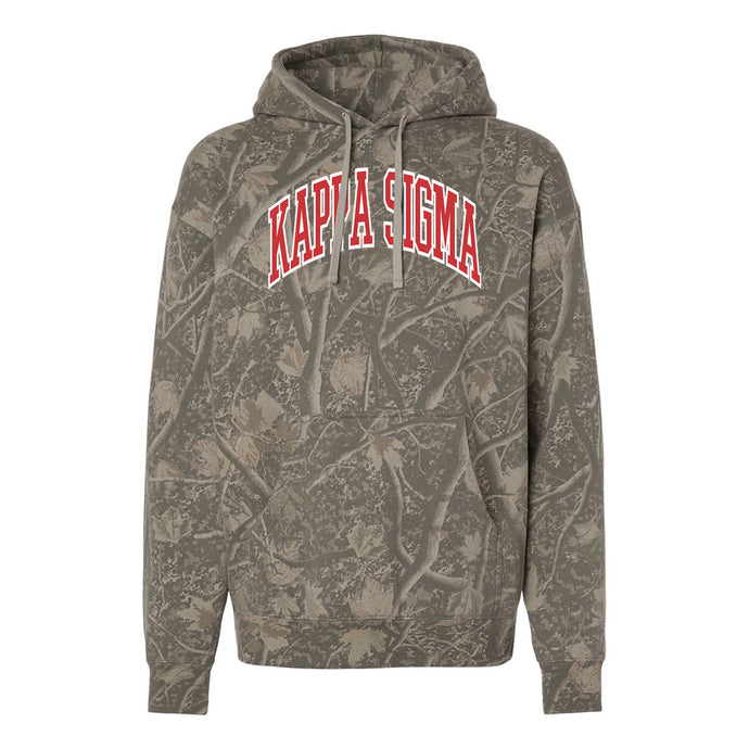 Kappa Sig Deadwood Camo Hoodie featuring an all-over woodland camouflage print, red and white arched Kappa Sigma lettering, drawstring hood, and kangaroo pocket.