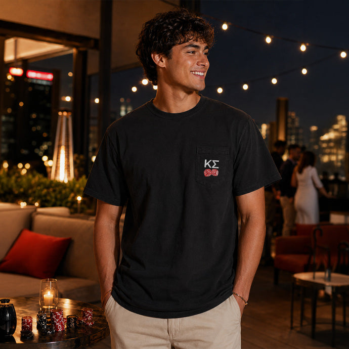 Model wearing the High Roller Tee from the front, featuring a chest pocket dice graphic on a black Comfort Colors tee.