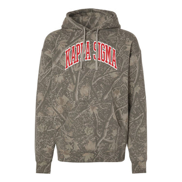 Kappa Sig Deadwood Camo Hoodie featuring an all-over woodland camouflage print, red and white arched Kappa Sigma lettering, drawstring hood, and kangaroo pocket.